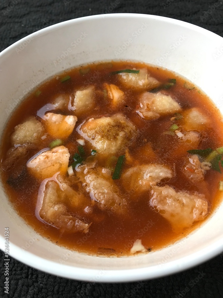 a serving of meatballs typical of Malang, East Java Indonesia. Isolated On a dark background a serving of meatballs typical of Malang, East Java Indonesia. Isolated On a dark background