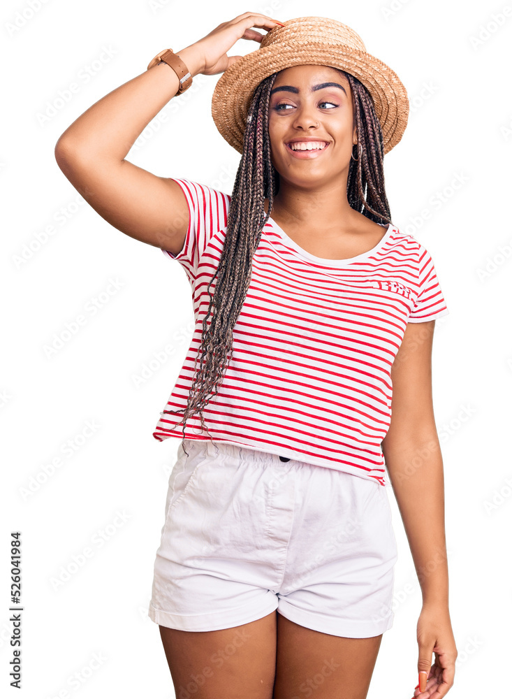 Young african american woman with braids wearing summer hat smiling confident touching hair with hand up gesture, posing attractive and fashionable