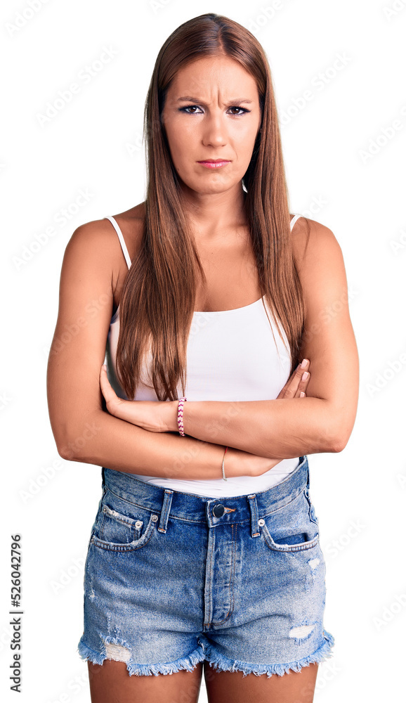 Young beautiful hispanic woman wearing casual clothes skeptic and nervous, disapproving expression on face with crossed arms. negative person. Young beautiful hispanic woman wearing casual clothes skeptic and nervous, disapproving expression on face with crossed arms. negative person.