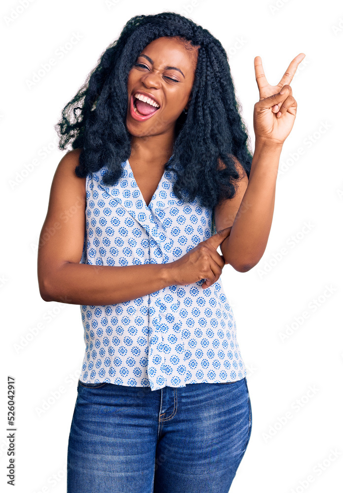 Beautiful african american woman wearing casual summer shirt smiling with happy face winking at the camera doing victory sign. number two. Beautiful african american woman wearing casual summer shirt smiling with happy face winking at the camera doing victory sign. number two.