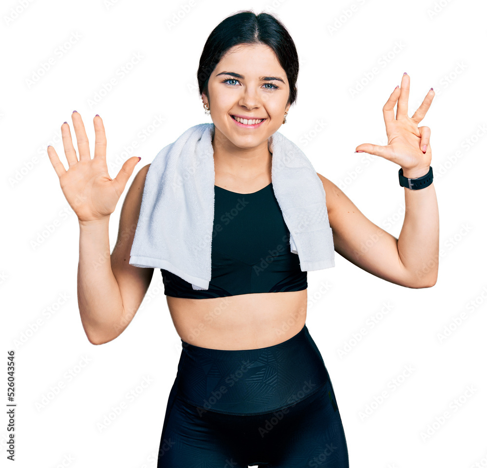 Young brunette woman with blue eyes wearing sportswear and towel showing and pointing up with fingers number nine while smiling confident and happy. Young brunette woman with blue eyes wearing sportswear and towel showing and pointing up with fingers number nine while smiling confident and happy.