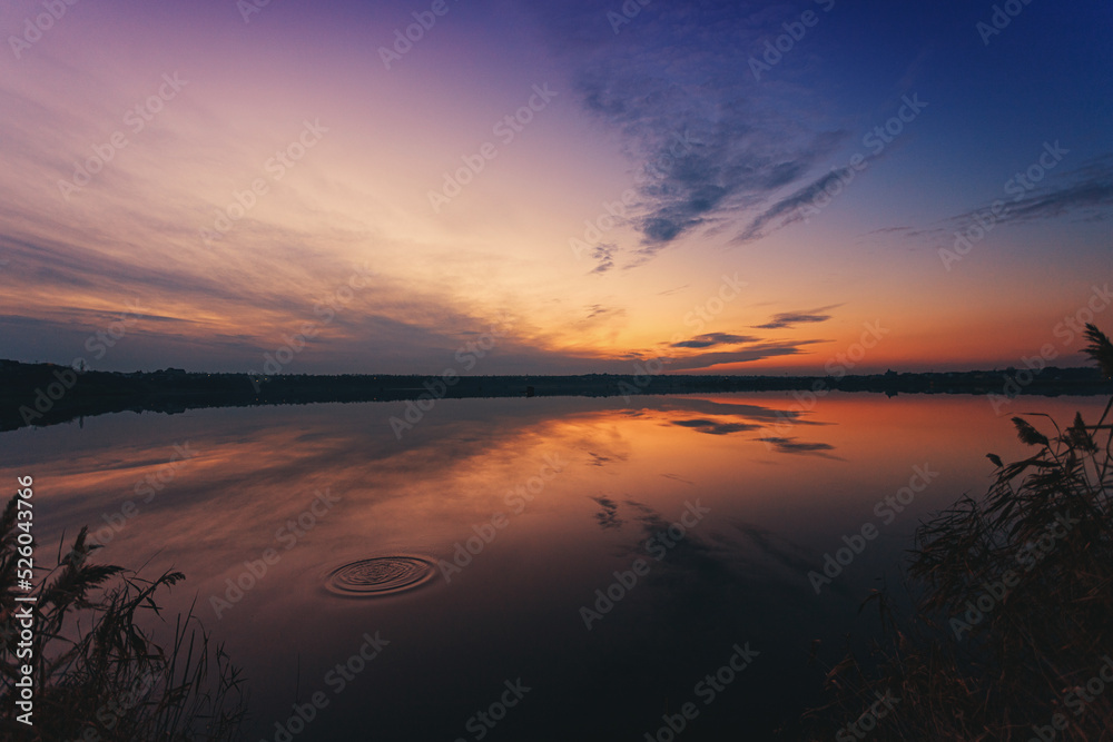 A wonderful dawn on the river with a reflection in the water