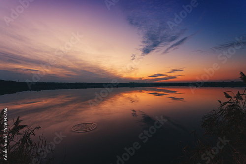 A wonderful dawn on the river with a reflection in the water © pobaralia