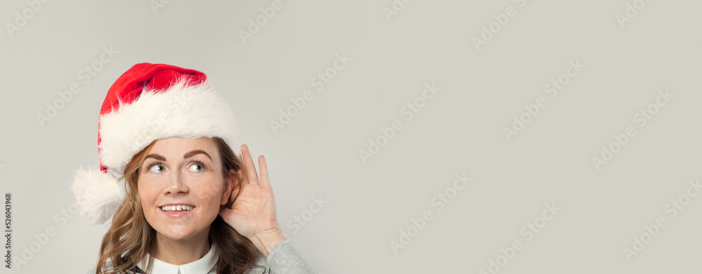 Fototapeta premium Christmas and New Year party concept. Happy woman listening - holiday is coming!