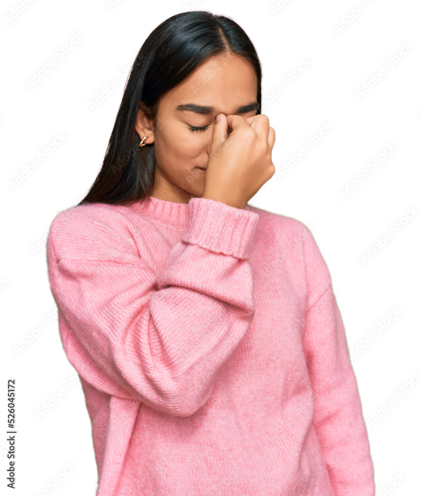 Young asian woman wearing casual winter sweater tired rubbing nose and eyes feeling fatigue and headache. stress and frustration concept. Young asian woman wearing casual winter sweater tired rubbing nose and eyes feeling fatigue and headache. stress and frustration concept.