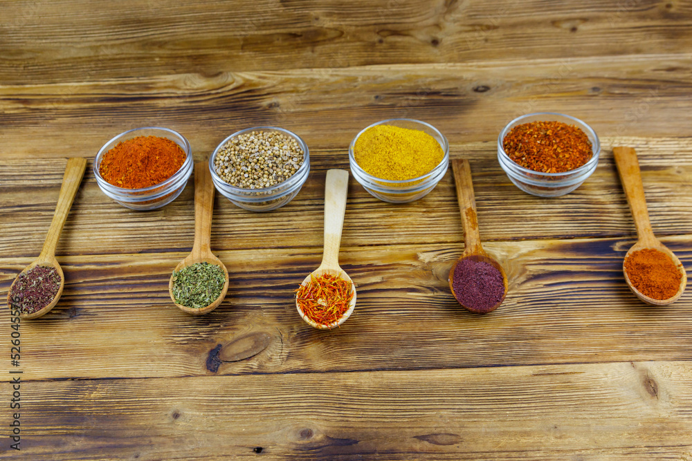 Set of different aromatic spices on wooden table Set of different aromatic spices on wooden table
