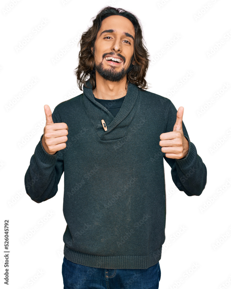 Young hispanic man wearing casual clothes success sign doing positive gesture with hand, thumbs up smiling and happy. cheerful expression and winner gesture.