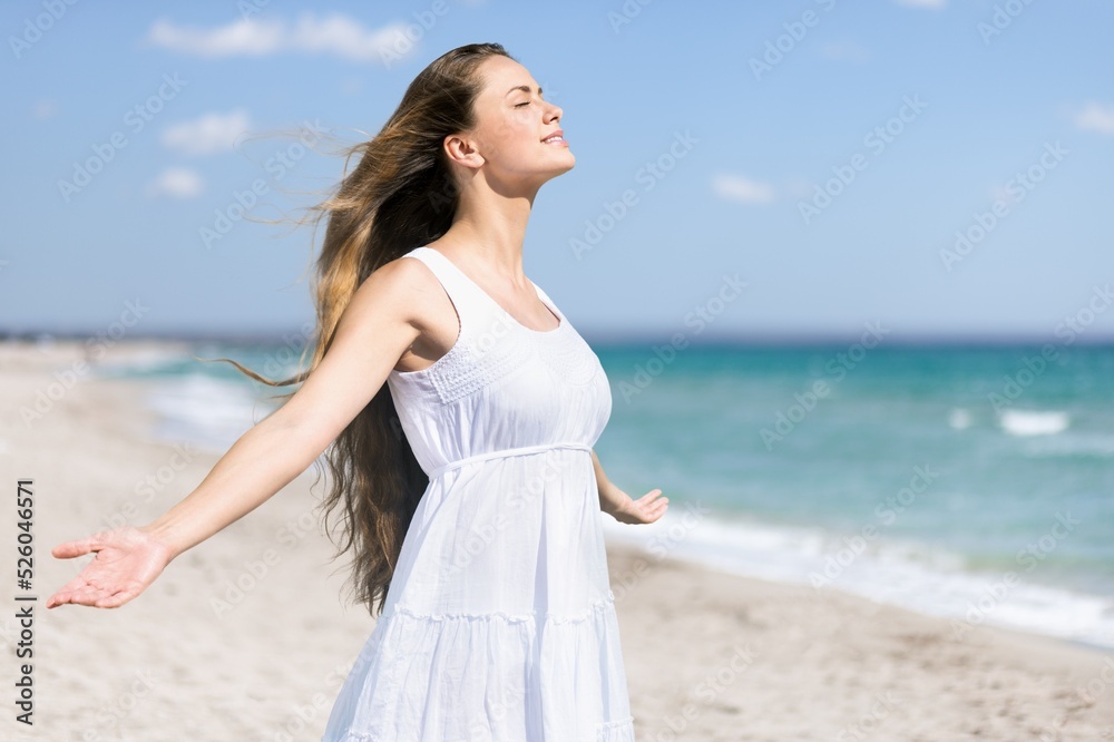 Stylish woman in elegant dress posing near the sea. Summer time. Travel, weekend, relax and lifestyle concept. Stylish woman in elegant dress posing near the sea. Summer time. Travel, weekend, relax and lifestyle concept.
