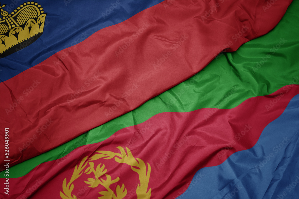 waving colorful flag of eritrea and national flag of liechtenstein. waving colorful flag of eritrea and national flag of liechtenstein.