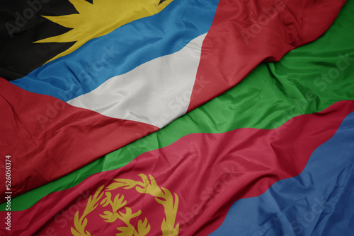waving colorful flag of eritrea and national flag of antigua and barbuda.