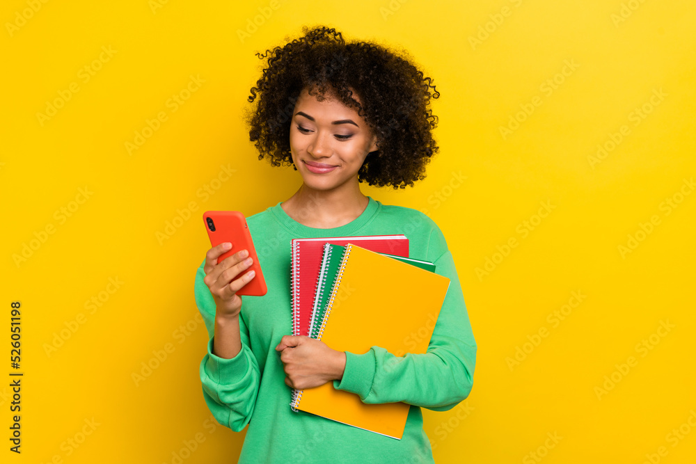 Portrait of nice person hold use telephone book copybook isolated on yellow color background Portrait of nice person hold use telephone book copybook isolated on yellow color background