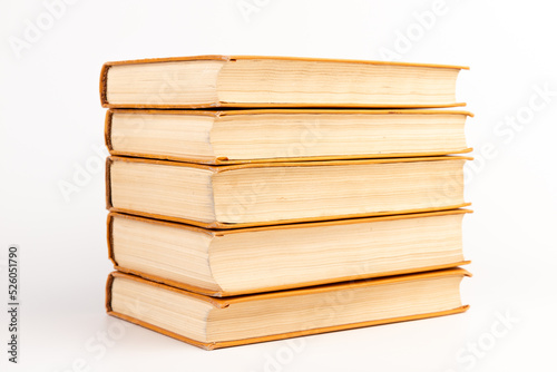 Stack of old books on light background. Book pile.