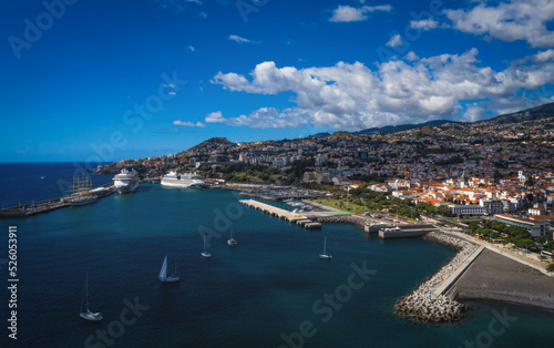 Scenery around Funchal, a city of the portuguese island named Madeira. View on harbour from the ocean. Aerial drone shot. October 2021 photo