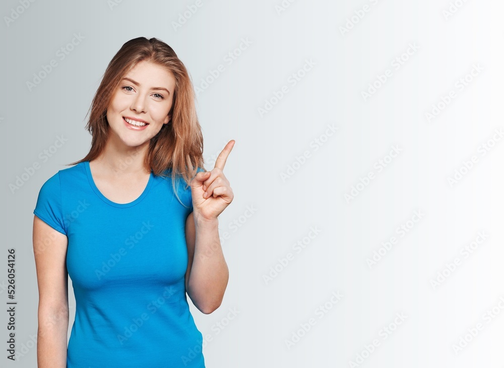 Happy student girl finger pointing on background. Happy student girl finger pointing on background.