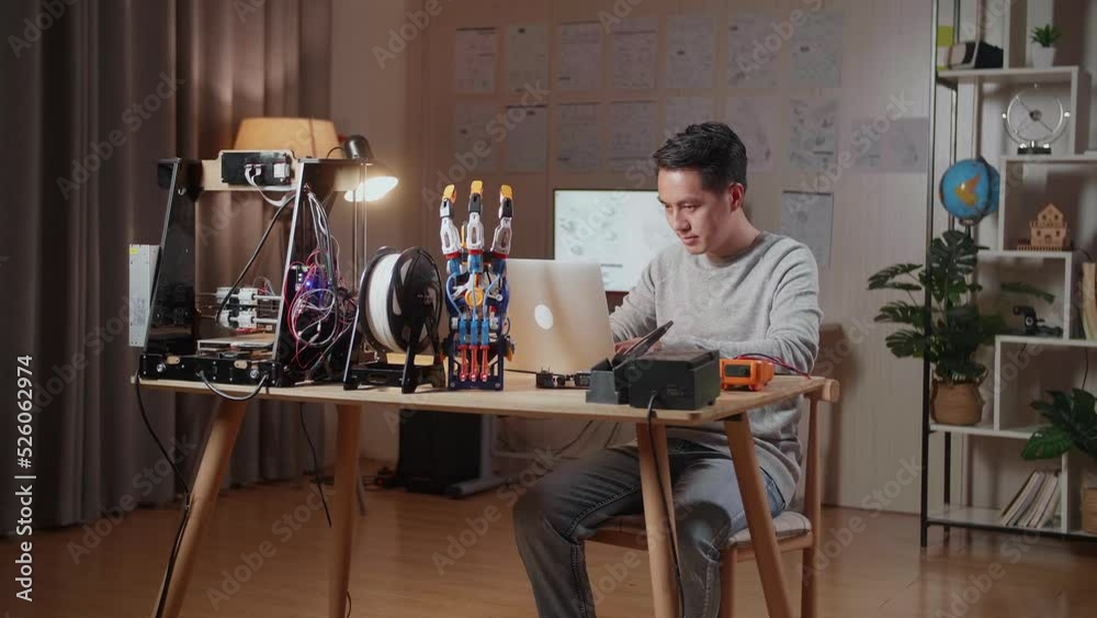 Asian Male With 3D Printing Working About A Cyborg Hand On A Laptop At Home
Asian Male With 3D Printing Working About A Cyborg Hand On A Laptop At Home
