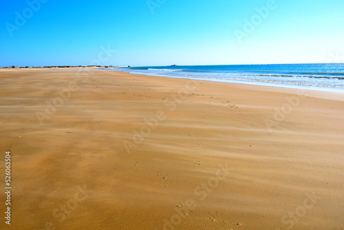 La Barrosa beach, in Sancti Petri, Cadiz, when the tide is low and there is a lot of sand. photo