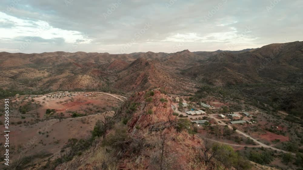 Flyover mountain rugged peak towards small village Arkaroola, Australia Flyover mountain rugged peak towards small village Arkaroola, Australia