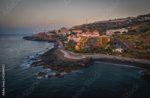Coastline of Canico de Baixo and hotels at sunrise. Madeira, october 2021. Aerial drone picture