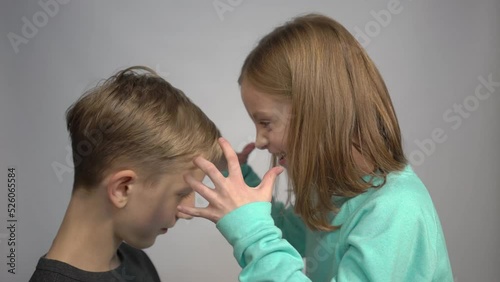 4k little girl screams on boy, hides his face with hands