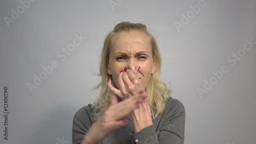 4k Blonde woman smelling something stinky and disgusting, intolerable smell