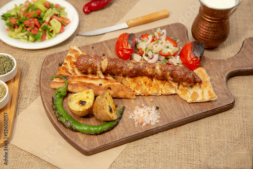 Turkish and Arabian Traditional Adana and Urfa kebab, minced meat kebab. Turkish food culture with salad on rustic wood textured background. Copy Space. stock photo
Kebab, Adana, Wrap Sandwich, Turkis