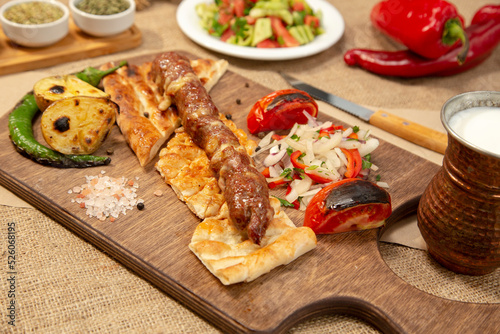 Turkish and Arabian Traditional Adana and Urfa kebab, minced meat kebab. Turkish food culture with salad on rustic wood textured background. Copy Space. stock photo
Kebab, Adana, Wrap Sandwich, Turkis