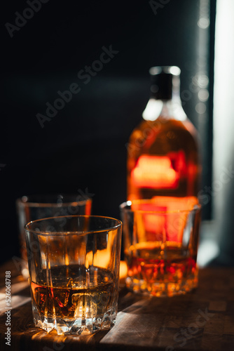 glass whiskey with bottle on background