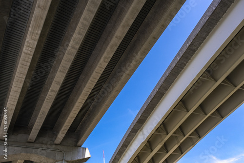 View Underneath a Large Bridge Highway on a Sunny Day with Blue Sky