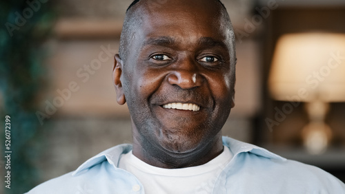 Close up surprised male portrait amazed face American African adult man 60s senior businessman grandfather standing at home feel shock say wow delight smiling enjoy happiness wining victory good news