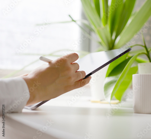 woman hand working on a tablet over white office background