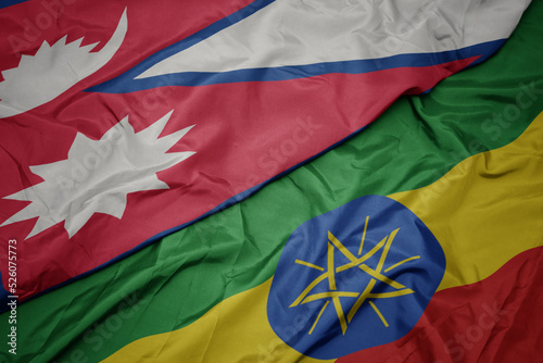 waving colorful flag of ethiopia and national flag of nepal.