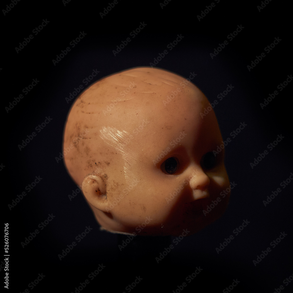 Damaged Dirty Doll head on black background Damaged Dirty Doll head on black background