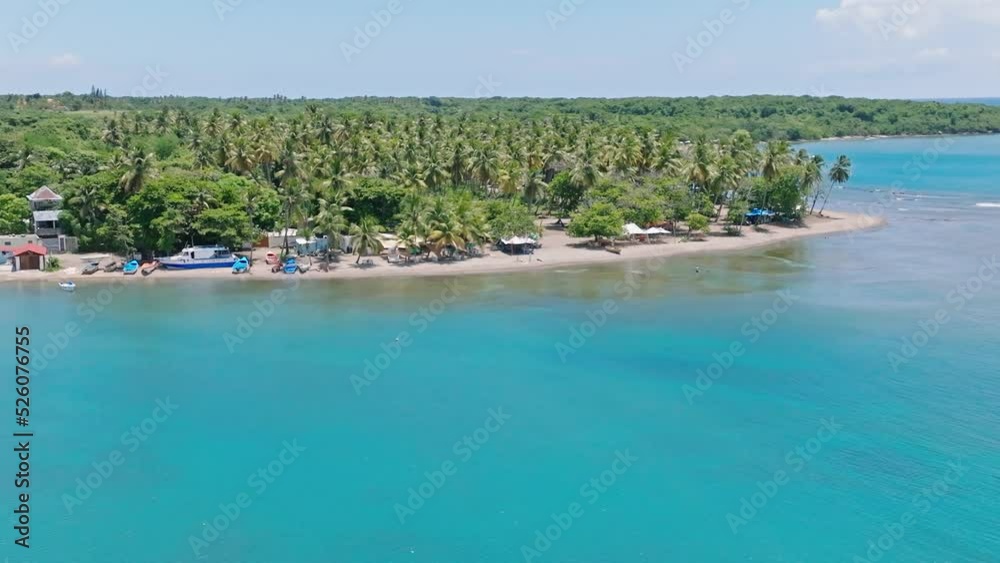 Aerial view of beautiful sandy beach, with turquoise water and tropical palm trees in summer Aerial view of beautiful sandy beach, with turquoise water and tropical palm trees in summer