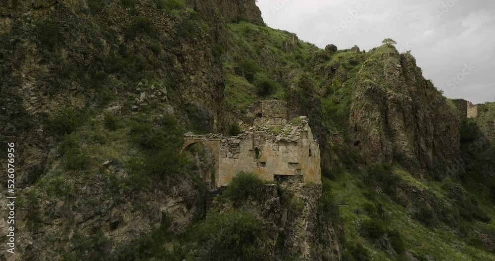 Rising Tmogvi Fortress Ruins In Caucasus Mountains In Samtskhe-Javakheti, Southern Georgia. Aerial Tilt-up Rising Tmogvi Fortress Ruins In Caucasus Mountains In Samtskhe-Javakheti, Southern Georgia. Aerial Tilt-up
