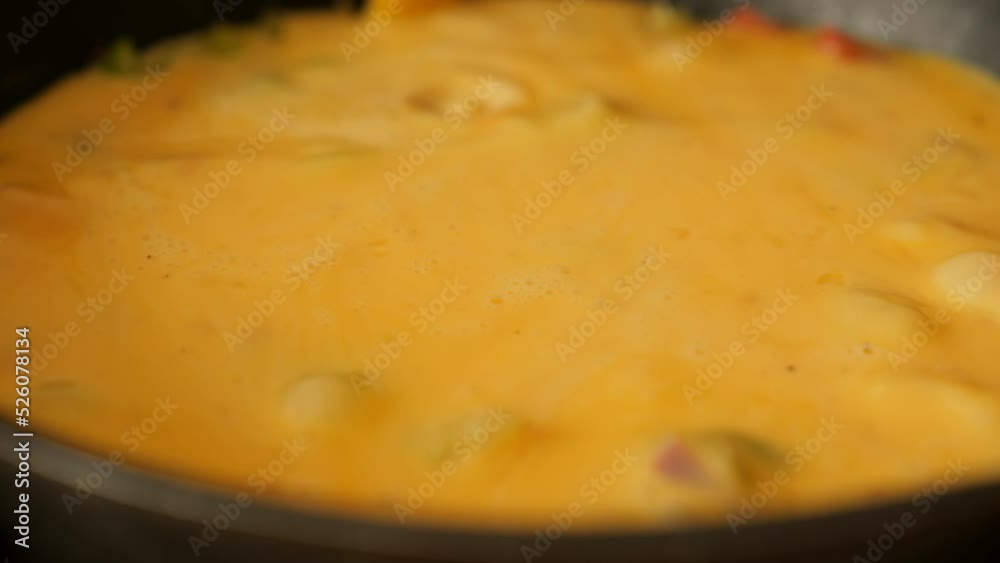 Preparing vegetables omelette on frying pan Preparing vegetables omelette on frying pan