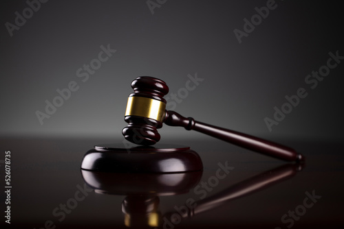 Gavel. Auction sale and business concept. Gavel and commercial code on the dark gray background.