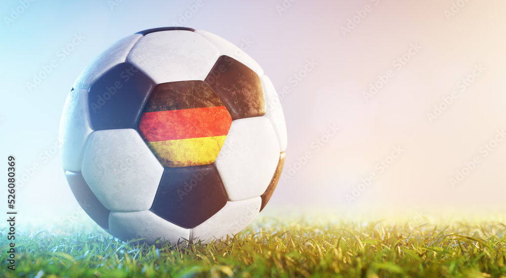 Football soccer ball with flag of Germany on grass