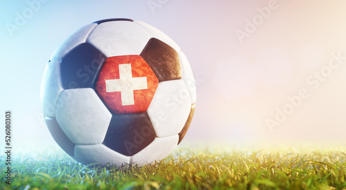 Football soccer ball with flag of Switzerland on grass