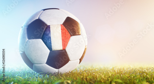 Football soccer ball with flag of France on grass