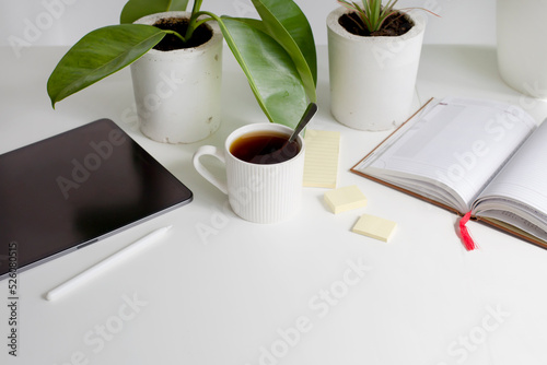 working place with cup of coffee and tablet photo