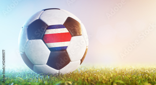 Football soccer ball with flag of Costa Rica on grass