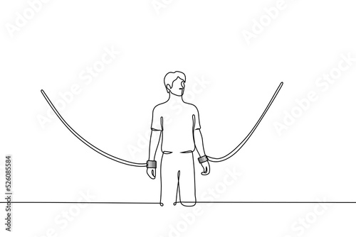Foto man stands captive by huge handcuffs against the walls - one line drawing vector