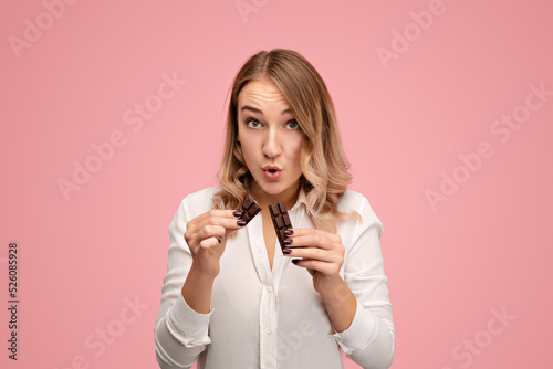 Young female breaking chocolate bar