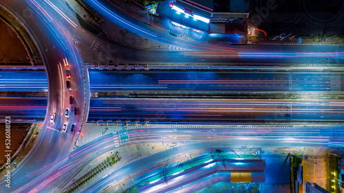 Expressway top view, Road traffic an important infrastructure,car traffic transportation above intersection road in city night, aerial view cityscape of advanced innovation, financial technology 