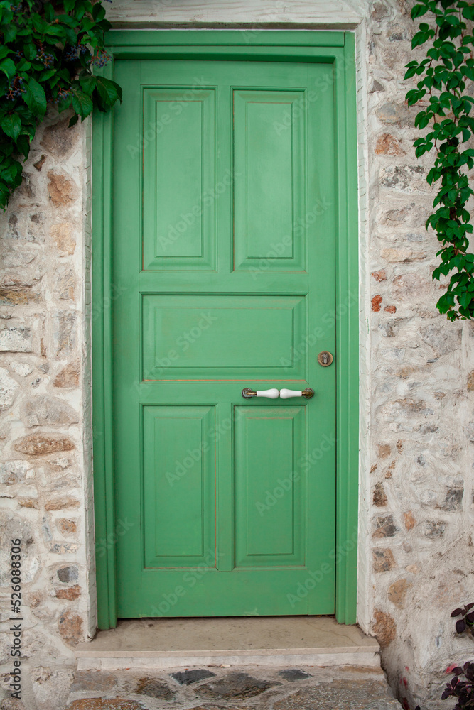 Front Door of a Old Stone House. Green Street Door Close Up. Front Door of a Old Stone House. Green Street Door Close Up.