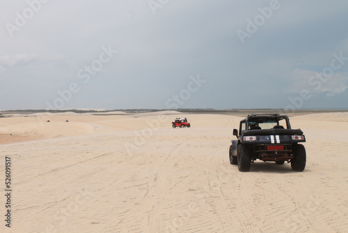 Buggy car used for tourist tours over the white sand dunes and isolated location on the coast of Brazil - Jericoacoara - Ceara