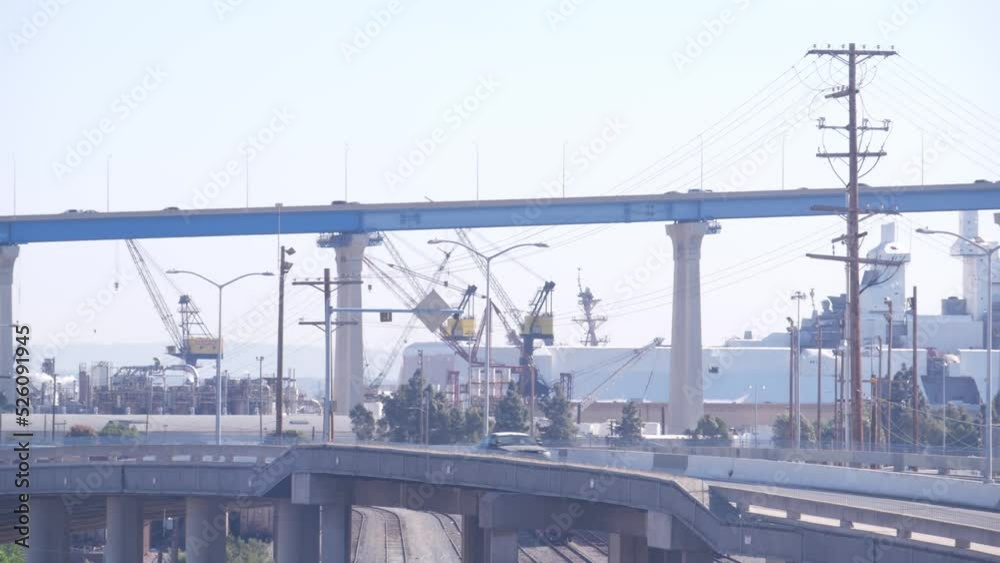 Industrial area, manufacturing or production district in San Diego, California USA. Coronado bridge and cars traffic. Fabrication and transportation infrastructure. Power lines or wires. Industrial area, manufacturing or production district in San Diego, California USA. Coronado bridge and cars traffic. Fabrication and transportation infrastructure. Power lines or wires.