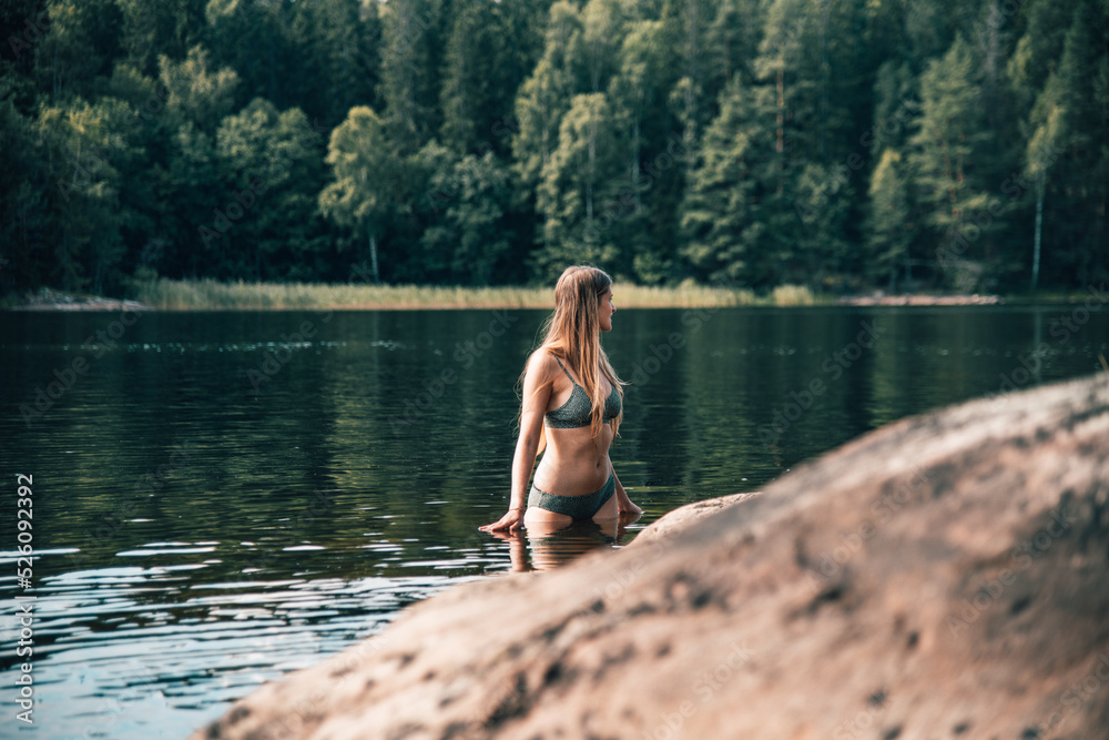 Girl in the lakes of Sweden. Photos | Adobe Stock