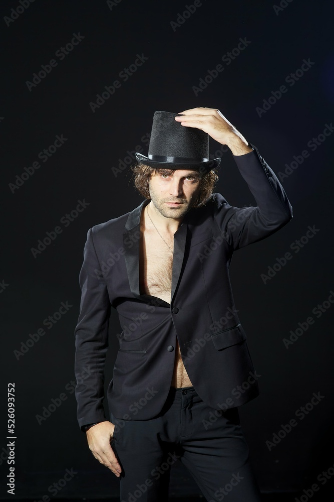 A man in stylish clothes on a dark background A man in stylish clothes on a dark background