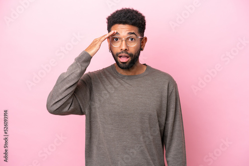 Young Brazilian man isolated on pink background has realized something and intending the solution